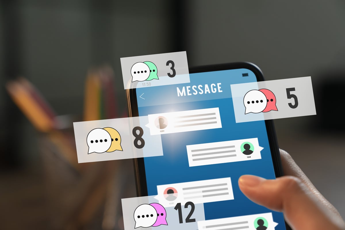 Hand holding smartphone and show screen new chat messages notification.